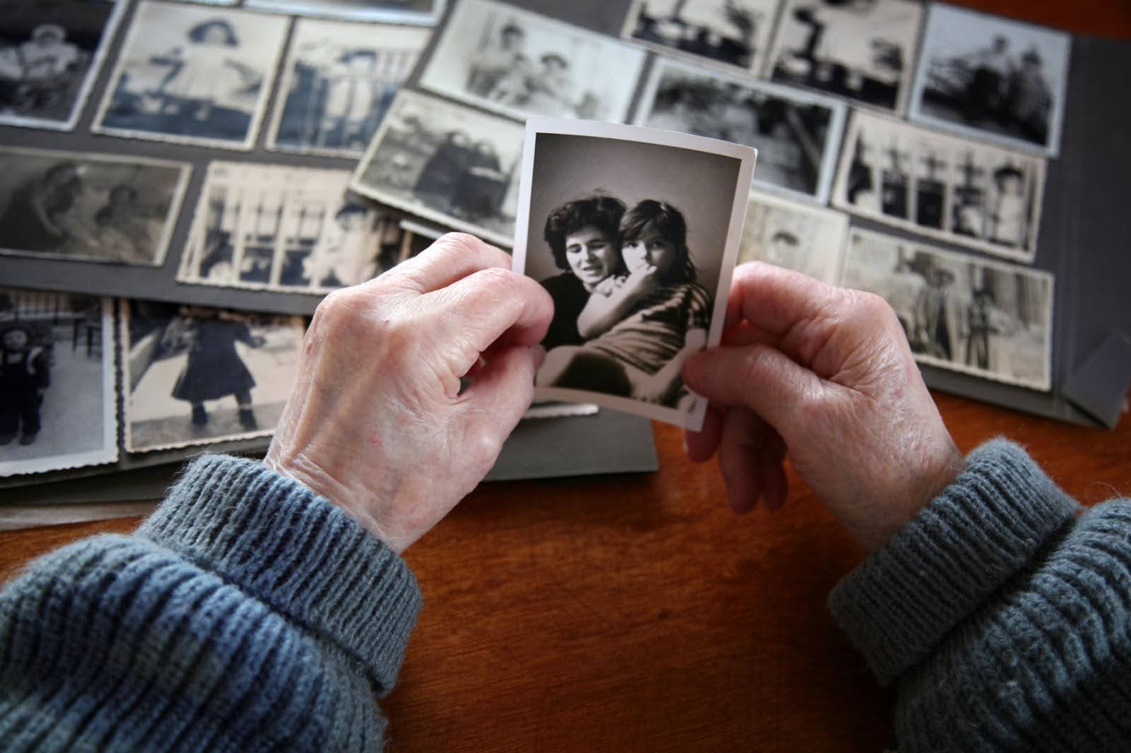 Elderly person looking through old photos